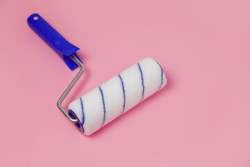 Paint roller isolated on pink