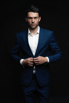 Handsome man wear blue suit isolated on black background