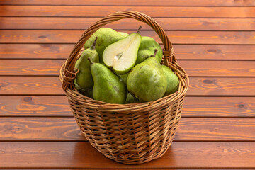 Bio sweet fresh pears from the farm. Healthy Organic Pears in the Basket on wooden rustic background. Healthy food full of vitamins. Pear harvest.Autumn nature concept. Tasty vegetarian snack.