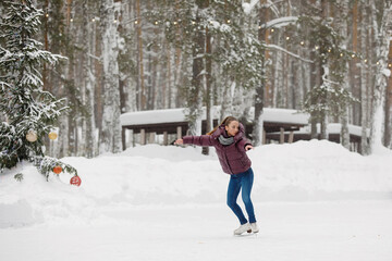 Girl skater at an outdoor rink in winter