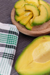 Healthy and fresh avocado slice on wooden plate.