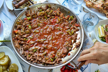round pot with adana kebab of meat and vegetables