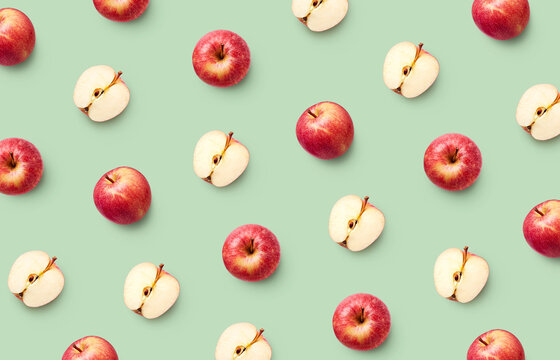 Colorful fruit pattern of fresh red apples on green background