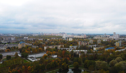 Top view of the autumn city near the park with trees