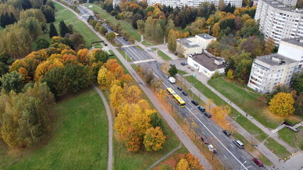 Top view of the autumn city near the park with trees