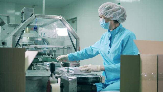 Drug packaging process. Health care, drugs production, pharmacist working, pharmaceutical manufacturing, pharmaceutical industry concept.