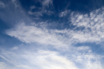 Stunning cirrus cloud formation panorama in a deep blue sky