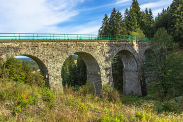 View of stone Railway Viaduct in a small village of Pernink, Czech republic. Old Czech railway line. Vintage arch bridge.