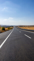 newly built asphalt road highway and vehicles long asphalt road,