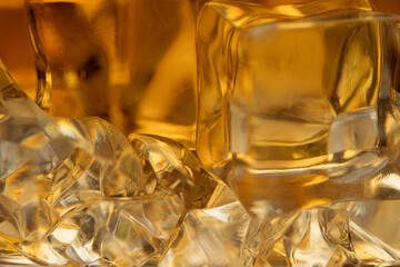 Whiskey with ice background close -up. Macro shot of whiskey and ice.
