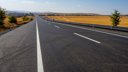 Fototapeta na wymiar newly built asphalt road highway and vehicles long asphalt road,