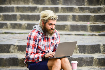 Remote job. When deadline coming. Fresh air. Mobile internet. Agile business. Bearded guy sit stairs background. Work and relax. Working online. Hipster inspired work in urban space. Modern laptop