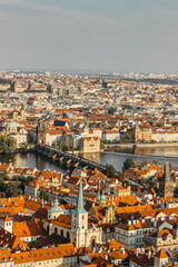 Fototapeta premium Aerial postcard view of Prague,Czechia. Prague panorama.Beautiful sunny landscape of the capital of Czechia.Amazing European cityscape.Red roofs,bridges over Vltava river.Travel urban scenery.