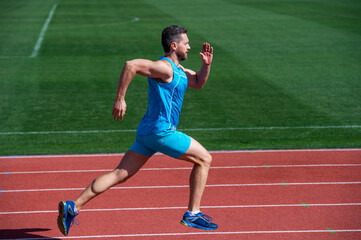 Fototapeta premium Great progress. muscular guy run to success. man running on stadium. sports healthy lifestyle routine. sport workout. male athlete do morning exercise. sportsman runner outdoor. health care. energy