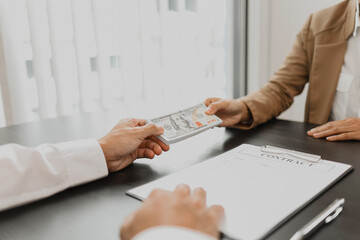 Business people giving dollar bribery for corruption contract.