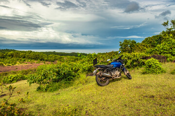 Fototapeta premium motorcycle at mountain top with amazing blue sky at morning