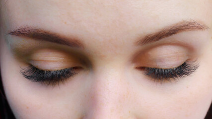 Concept of beauty and fashion. Banner women's eyes with long false eyelashes. Macro snapshot.