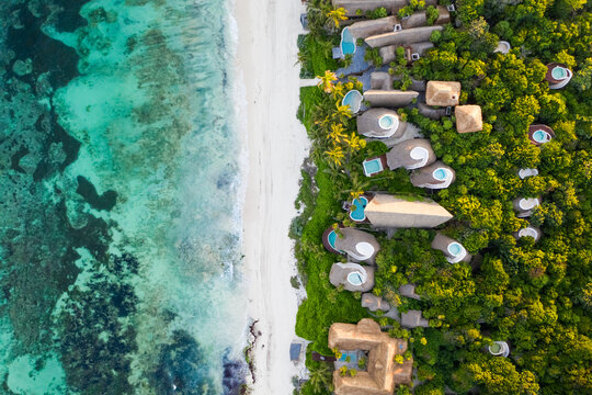 Aerial view of bungalow resorts on the Tulum coast in Mexico.