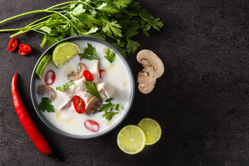 Traditional Thai food Tom Kha Gai in bowl on black background. Top view.Copy space