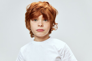 portrait of a redhead boy white t-shirt close-up cropped view 