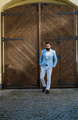 Portrait of mature guy wearing jacket and looking at camera outdoor, male beauty