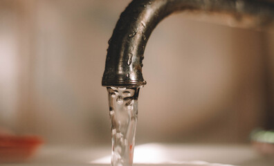 water pours from the tap