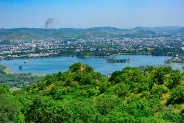 Fototapeta na wymiar Panoramic aerial view of Udaipur city also known as city of lakes from Monsoon palace at Sajjangarh, Rajasthan. It is the historic capital of the kingdom of Mewar.