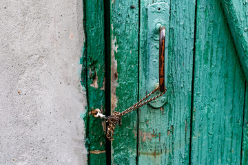 Old vintage door handles. Rusty metal locks and latches. Protective devices for wooden yard gates
