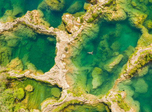 Aerial view of woman in swimsuit bathing in the El Salto waterfalls, Mexico. - Powered by Adobe