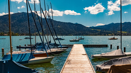 Beautiful alpine view with boats and reflections at the famous Tegernsee, Bavaria, Germany