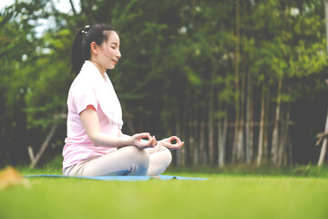 Young woman doing yoga in morning backyard at home. Outdoor workout healthy lifestyle concept.