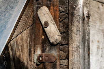 Old vintage door handles. Rusty metal locks and latches. Protective devices for wooden yard gates