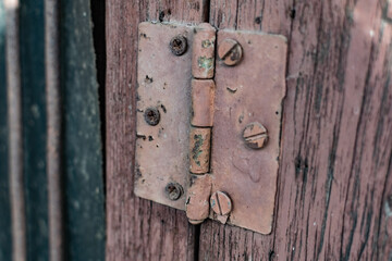 Old vintage door handles. Rusty metal locks and latches. Protective devices for wooden yard gates