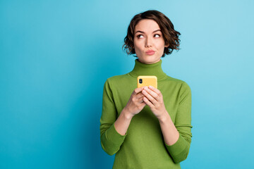 Photo of minded unsure girl use smartphone want type text dont know what about wear green style...