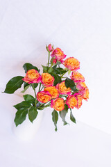 Small Pink and Orange Cut Roses in White Vase
