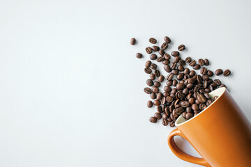 coffee beans in brown glass on white table background. top view. space for text