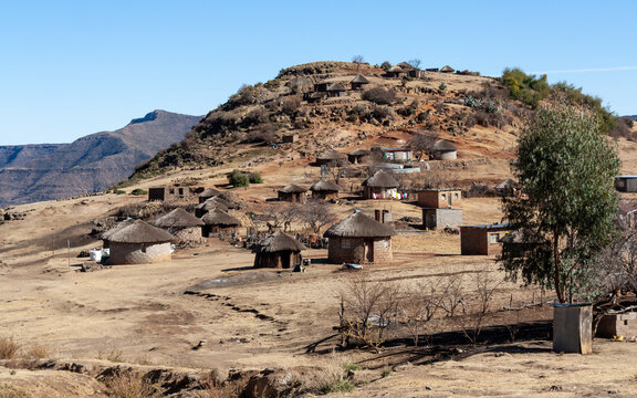 A village in Lesotho dominated by traditional round thatched roofed huts. Life in rural areas of the country is far from that of Western countries.