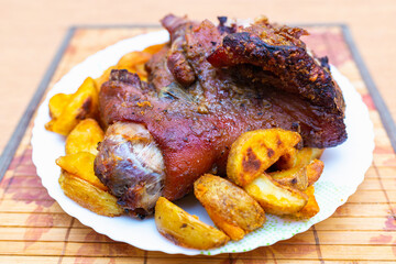 Top view tasty pork shank and mashed potato on the plate closeup. Vertical