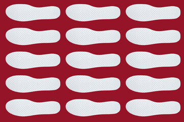 Pattern with Shoe insoles on a red background.