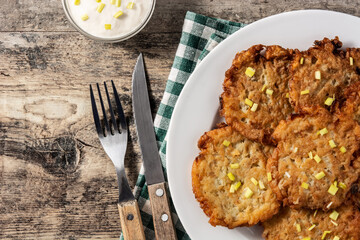 Traditional Jewish latkes or potato pancakes on wooden table.Top view. Copy space