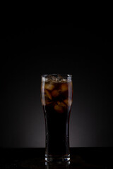 Cola drink served in a glass with ice