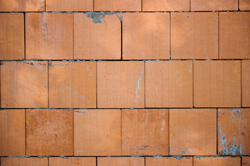 Big orange block construction wall with cement background texture
