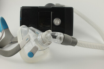 CPAP machine with adult full face mask for the treatment of sleep apnoea, isolated on a white background - 385318172