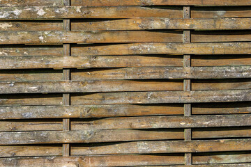Weathered and damaged old wooden fence background texture detailed close up
