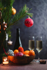 The celebration of Christmas and the New year with champagne. The new year's holiday is decorated with a table. Two glasses of champagne, vintage tinted