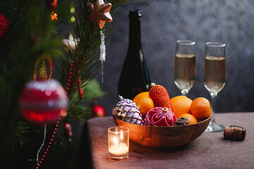 The celebration of Christmas and the New year with champagne. The new year's holiday is decorated with a table. Two glasses of champagne, vintage tinted	
