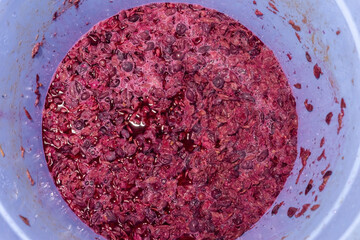 top view the texture of squeezed grape juice with crushed pink berries