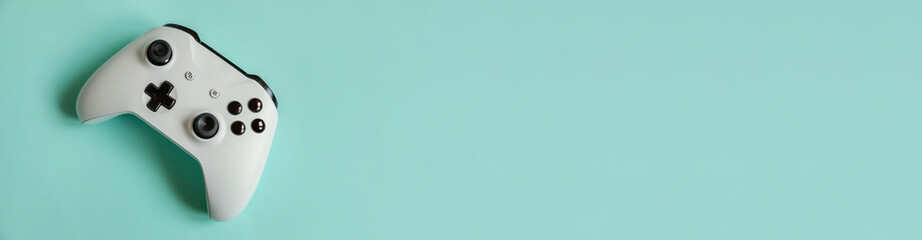 White joystick gamepad, game console isolated on pastel blue colourful trendy background. Computer gaming competition videogame control confrontation concept. Cyberspace symbol. Banner © Юлия Завалишина