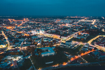 Grodno, Belarus. Night Aerial View Of Hrodna Cityscape Skyline. Famous Historic Landmarks In Lightning. Castles, Theater, Francis Xavier Cathedral, Catholic Church Of Discovery Of Holy Cross