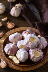Garlic. Garlic Cloves and Bulb on rustic wooden table.